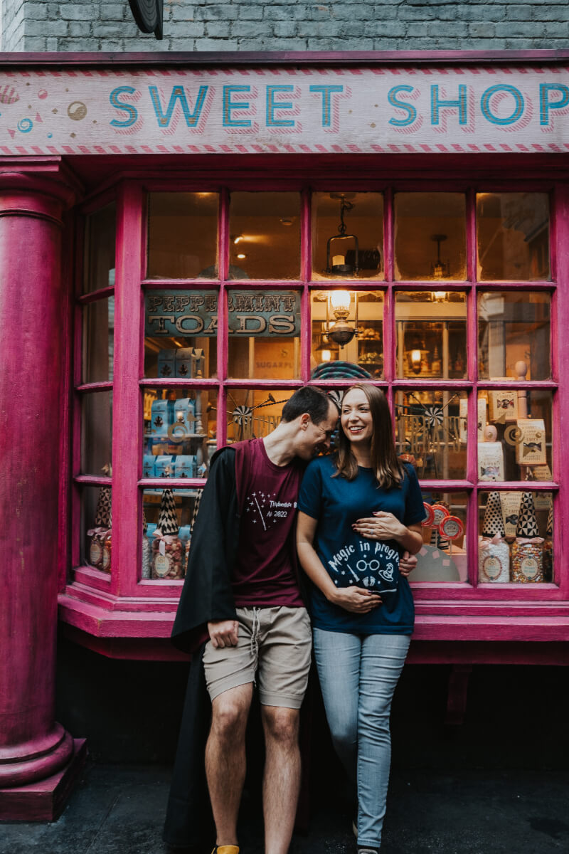 Pregnant Mom + Husband Posing in Diagon Alley